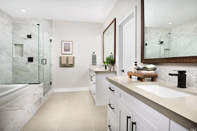 bathroom with tile patterned floors, vanity, and separate shower and tub