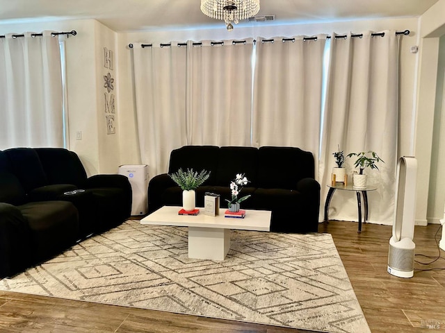 living room featuring a chandelier and hardwood / wood-style flooring