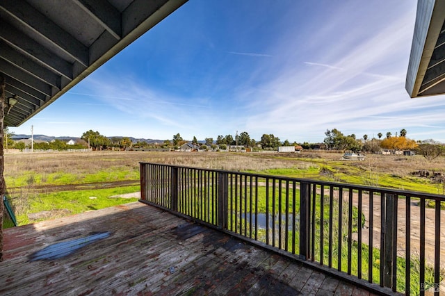 wooden terrace featuring a rural view