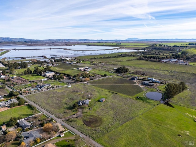 birds eye view of property with a water view and a rural view