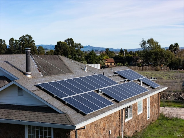 exterior space featuring a mountain view and solar panels