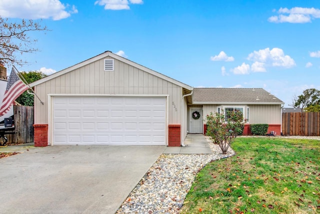 ranch-style home featuring a garage and a front yard