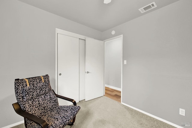 living area with light carpet