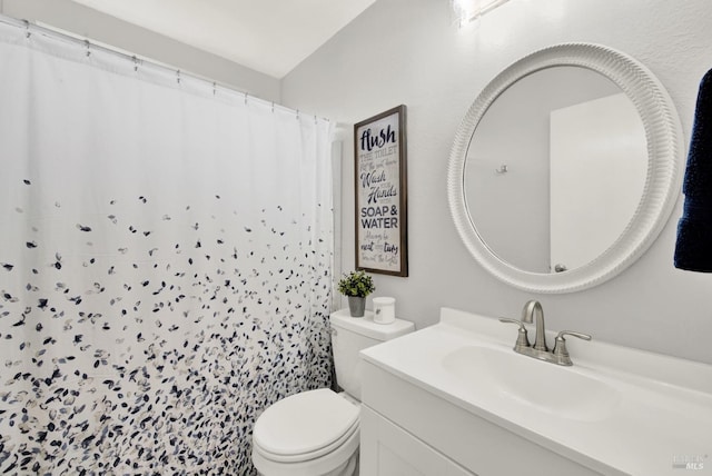 bathroom with walk in shower, vanity, and toilet