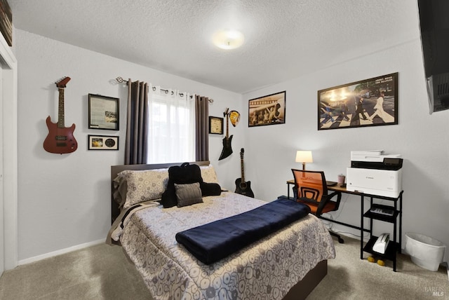 bedroom featuring carpet floors and a textured ceiling