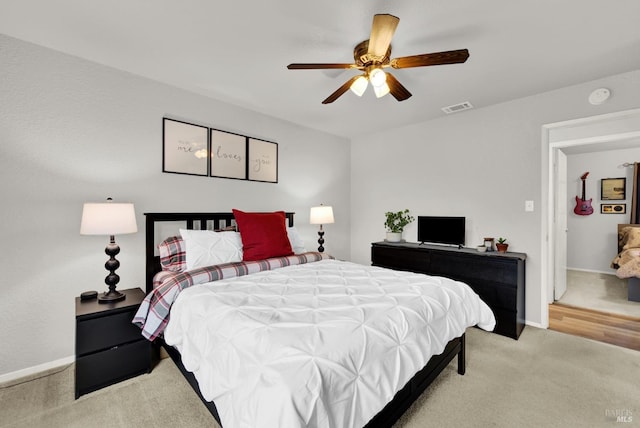 bedroom featuring light colored carpet and ceiling fan