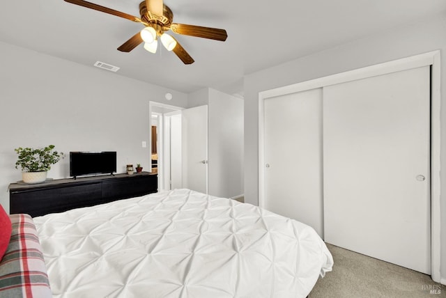 carpeted bedroom with a closet and ceiling fan