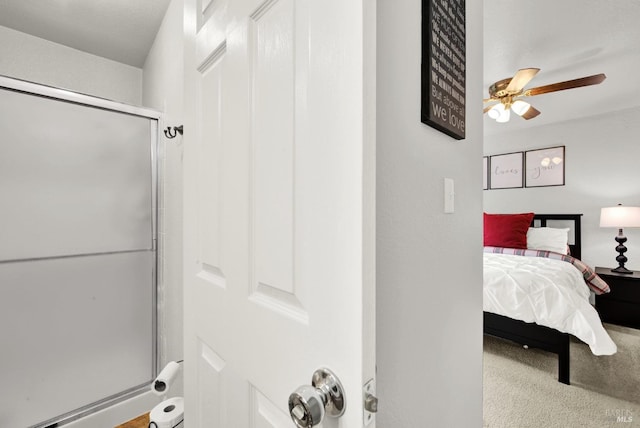 bathroom featuring walk in shower and ceiling fan