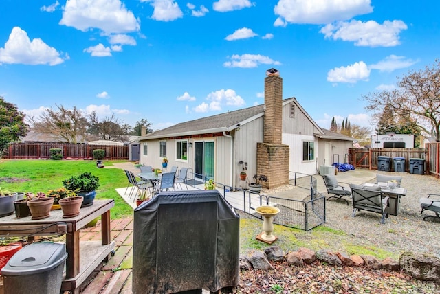 back of property with a yard and a patio