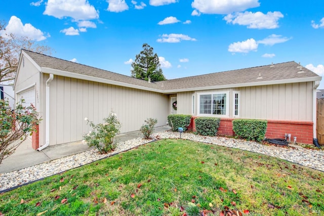 view of front of house with a garage and a front lawn