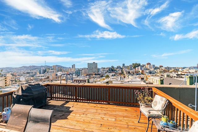 deck with a mountain view and area for grilling