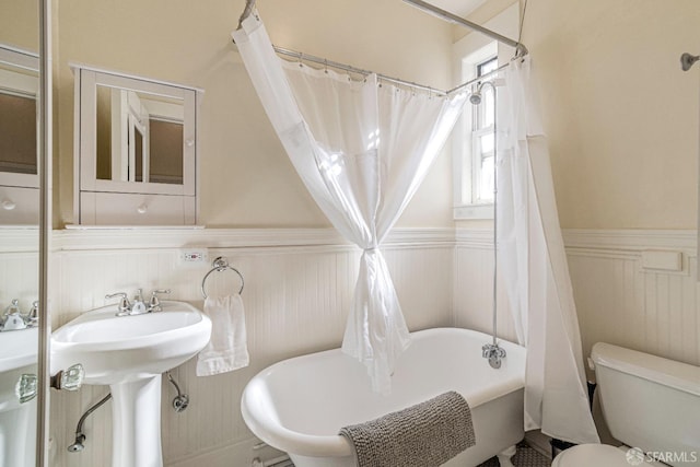 bathroom with shower / bath combo and toilet