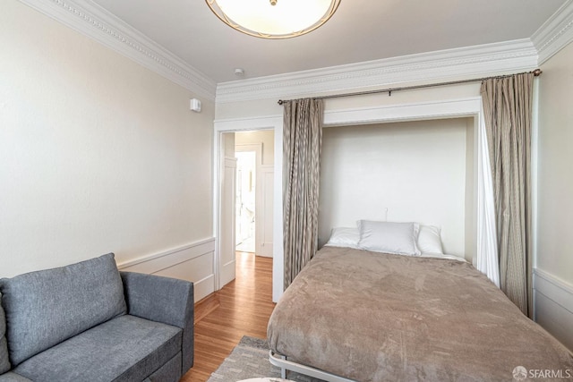 bedroom featuring crown molding and hardwood / wood-style flooring