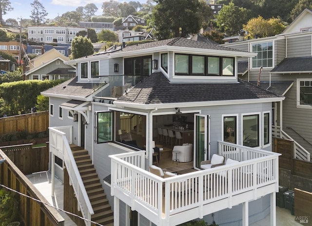 rear view of property featuring a wooden deck