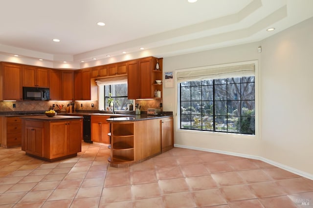 kitchen with a center island, light tile patterned floors, sink, and tasteful backsplash