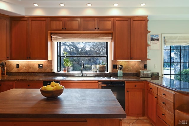 kitchen with dishwasher, sink, wooden counters, decorative backsplash, and light tile patterned flooring