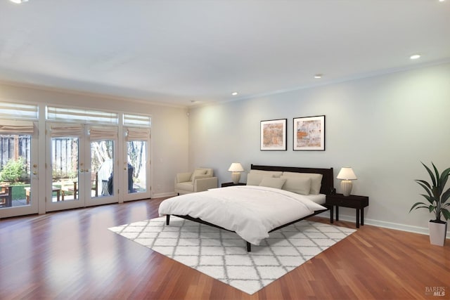 bedroom featuring access to exterior, french doors, light hardwood / wood-style floors, and crown molding