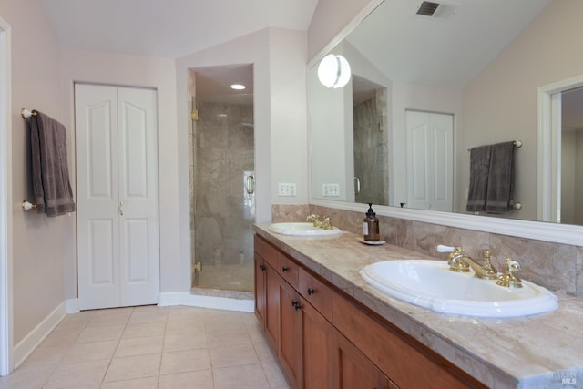 bathroom featuring tile patterned floors, vanity, a shower with shower door, and vaulted ceiling