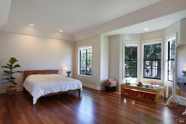 bedroom with vaulted ceiling and dark wood-type flooring