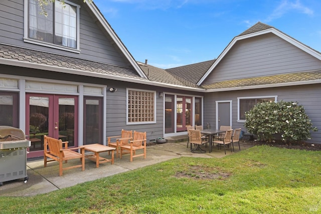 back of property featuring a lawn, a patio area, and french doors