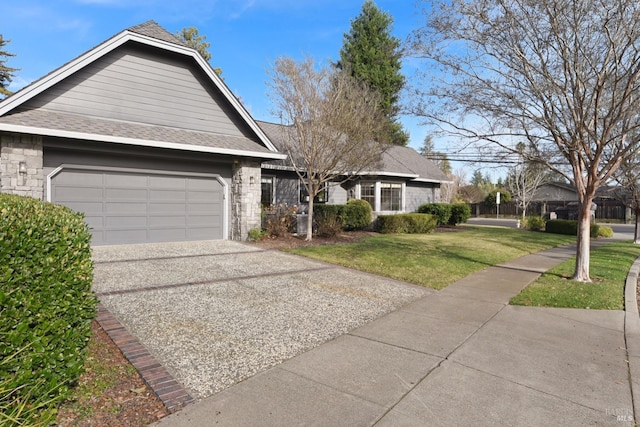 ranch-style house featuring a garage and a front lawn