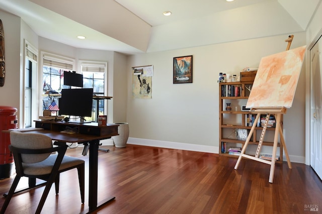 home office with hardwood / wood-style flooring and a raised ceiling