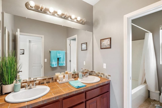 bathroom featuring shower / bathtub combination with curtain and vanity