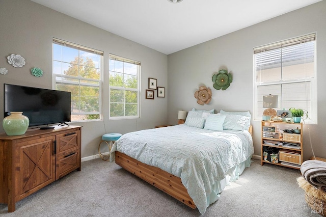 bedroom featuring light carpet