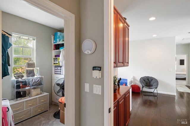 hall featuring washer / clothes dryer, dark wood-style flooring, baseboards, and recessed lighting