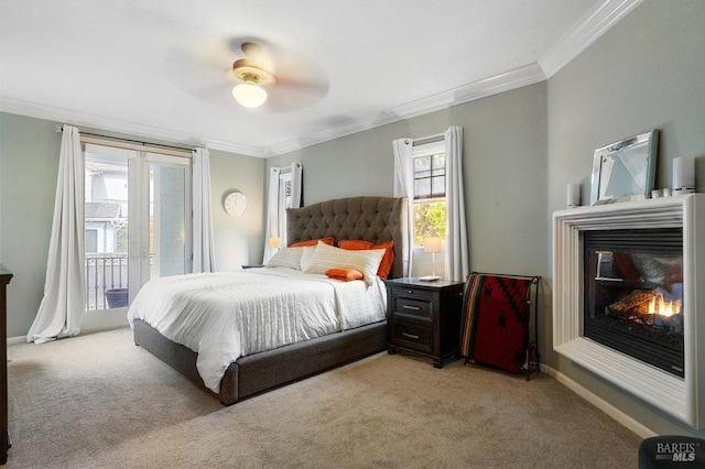 bedroom with crown molding, a glass covered fireplace, light carpet, ceiling fan, and access to outside