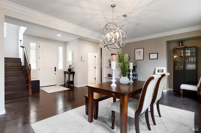 dining area with crown molding, wood-type flooring, and a notable chandelier