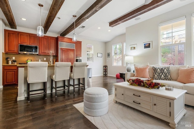 living room with lofted ceiling with beams, dark wood finished floors, recessed lighting, baseboards, and visible vents
