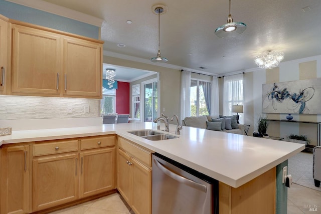 kitchen with a chandelier, kitchen peninsula, stainless steel dishwasher, and sink