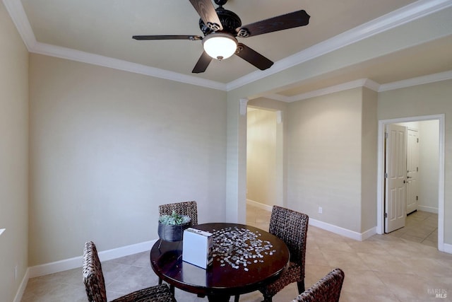 dining space with ceiling fan, crown molding, and light tile patterned flooring