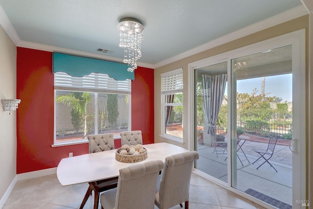 dining space with crown molding, plenty of natural light, light tile patterned flooring, and a notable chandelier