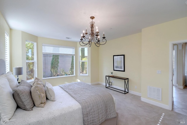 carpeted bedroom featuring a notable chandelier