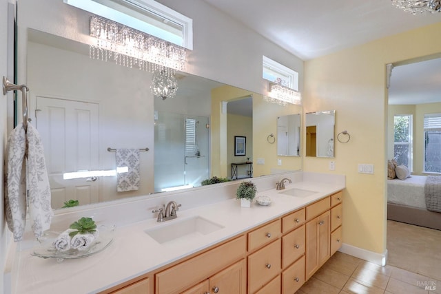 bathroom with tile patterned flooring, vanity, a chandelier, and an enclosed shower