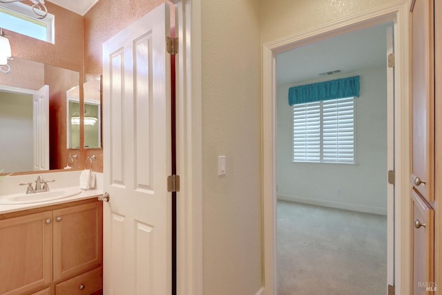 bathroom with plenty of natural light and vanity