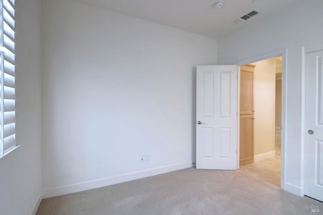 unfurnished bedroom featuring light carpet