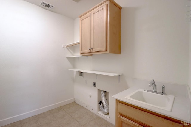 washroom featuring cabinets, hookup for a gas dryer, electric dryer hookup, and sink