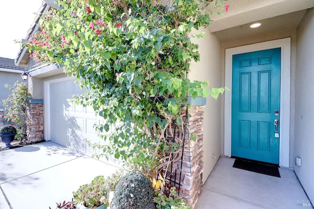 view of exterior entry with a garage