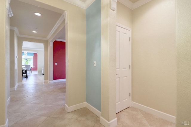 hallway featuring light tile patterned flooring and ornamental molding