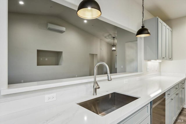 kitchen with pendant lighting, sink, white cabinets, light stone countertops, and a wall unit AC