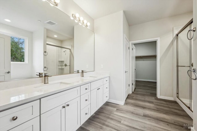 18904 Timber Point Ct, Hidden Valley Lake, CA 95467 - bathroom with double vanity, visible vents, a stall shower, and a sink