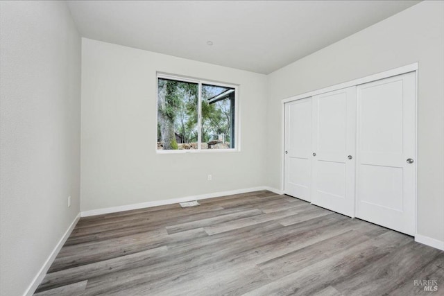 18904 Timber Point Ct, Hidden Valley Lake, CA 95467 - unfurnished bedroom featuring a closet, wood finished floors, and baseboards