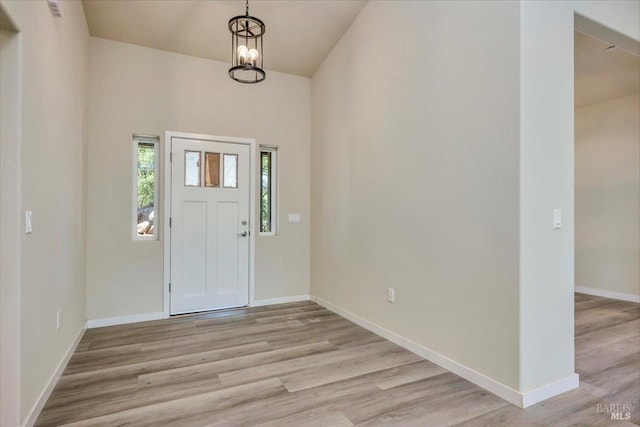 entryway featuring a chandelier and light hardwood / wood-style flooring