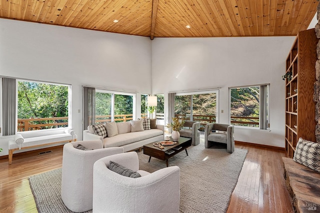 sunroom / solarium with lofted ceiling, wooden ceiling, and plenty of natural light