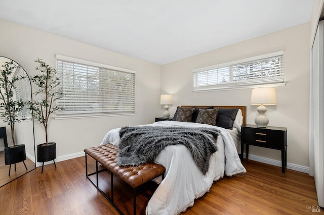 bedroom featuring wood finished floors and baseboards