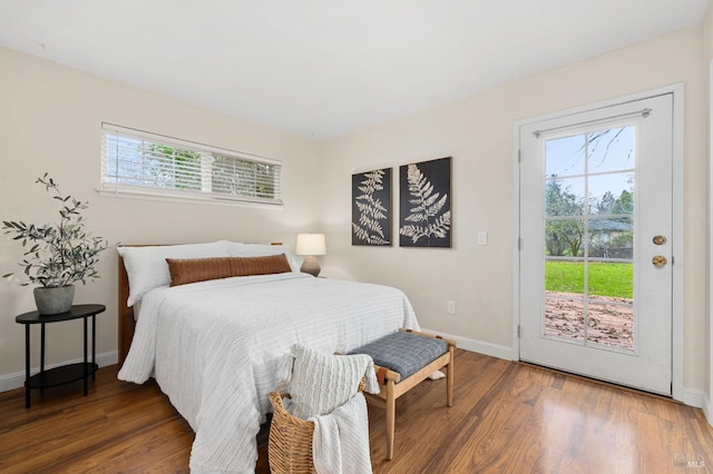 bedroom with access to exterior, baseboards, and dark wood-style floors