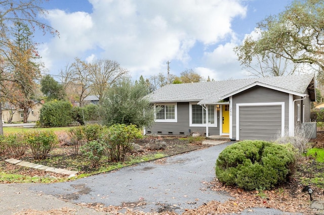 ranch-style home featuring aphalt driveway, crawl space, a shingled roof, and an attached garage